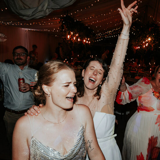 Newly married couple sharing their first dance together during their evening wedding reception.