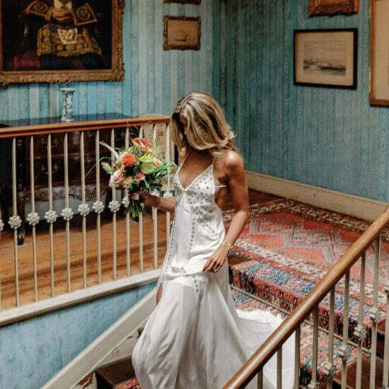 Bride walking down stairs.
